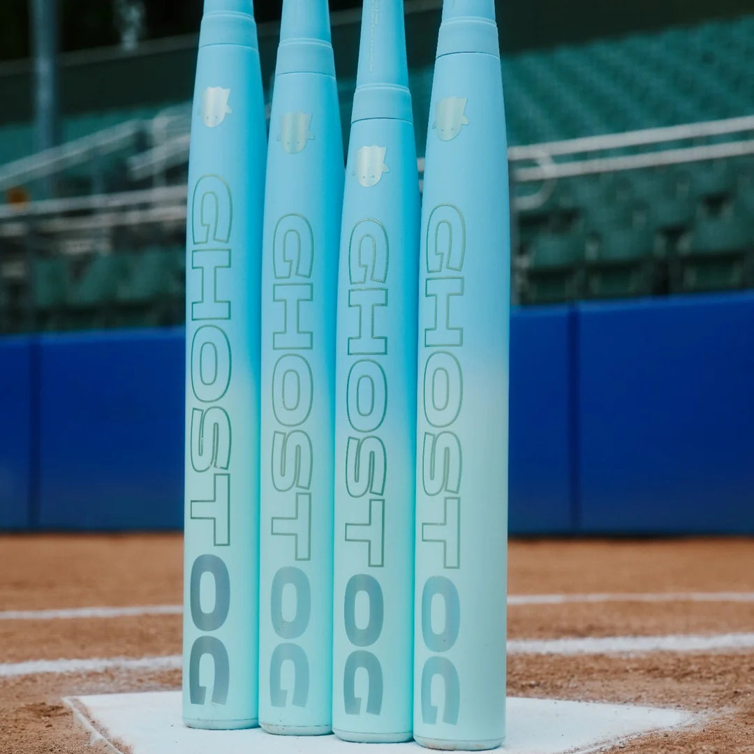 Four Easton Ghost OG fastpitch bats standing on home plate